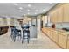 Open kitchen area with island seating, bright cabinets, and hardwood flooring at 2885 W 115Th Dr, Denver, CO 80234