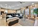 Open-concept living room with a comfortable leather couch, a ceiling fan and neutral-toned decor at 2885 W 115Th Dr, Denver, CO 80234