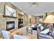 Living room featuring a stone fireplace wall and hardwood flooring at 2885 W 115Th Dr, Denver, CO 80234