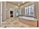 Main bathroom featuring a large bathtub and walk-in shower at 2885 W 115Th Dr, Denver, CO 80234