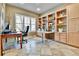 Comfortable office with built-in shelves, a large window, and ample workspace at 2885 W 115Th Dr, Denver, CO 80234