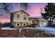 Two-story house with solar panels and a snow-covered yard at 4582 Granby Way, Denver, CO 80239