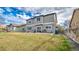 Large fenced backyard with a well-maintained lawn, patio, and barbecue area, perfect for outdoor entertaining at 14873 E 119Th Ave, Commerce City, CO 80603