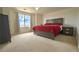 Cozy bedroom with a large window and plush red bedding at 14873 E 119Th Ave, Commerce City, CO 80603