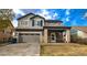 Charming two-story home with a two car garage, front porch, blue shutters, and solar panels at 14873 E 119Th Ave, Commerce City, CO 80603