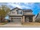 Charming two-story home featuring solar panels, a well-kept lawn and a two-car garage at 14873 E 119Th Ave, Commerce City, CO 80603