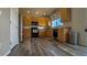 Well-lit kitchen with wood cabinets, hardwood floors, stainless steel appliances and granite counters at 14873 E 119Th Ave, Commerce City, CO 80603