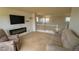 Inviting living room with a fireplace, TV, and neutral-toned furnishings at 14873 E 119Th Ave, Commerce City, CO 80603