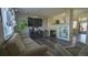 Inviting living room with a fireplace, hardwood floors, a large tv and a comfortable couch at 14873 E 119Th Ave, Commerce City, CO 80603