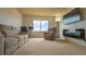 Comfortable living room with a fireplace, TV, and window views at 14873 E 119Th Ave, Commerce City, CO 80603