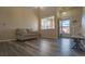 Living room with large window, hardwood floors, and a comfortable couch at 14873 E 119Th Ave, Commerce City, CO 80603