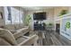 Inviting living room with a fireplace, hardwood floors, a large tv and a comfortable couch at 14873 E 119Th Ave, Commerce City, CO 80603