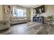 Inviting living room with a fireplace, hardwood floors, a large tv and a comfortable couch at 14873 E 119Th Ave, Commerce City, CO 80603