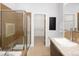 Bathroom featuring a glass-enclosed shower and tiled walls, complemented by a modern vanity and sink at 2900 Inca St # 7, Denver, CO 80202