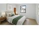 Bright bedroom with white walls, a black-framed window, and neutral décor creating a calming atmosphere at 2900 Inca St # 7, Denver, CO 80202
