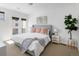 Bright bedroom with soft bedding, modern art, and a door to a balcony or patio area at 2900 Inca St # 7, Denver, CO 80202