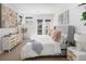 Bright bedroom featuring a soft gray bed, modern art, and a door to the outside at 2900 Inca St # 7, Denver, CO 80202