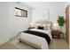 Bright bedroom with minimalist design, including a modern bed, neutral tones and a window view at 2900 Inca St # 7, Denver, CO 80202
