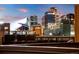 Rooftop deck with a sweeping view of the illuminated skyline against the twilight sky at 2900 Inca St # 7, Denver, CO 80202