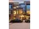 A modern brown brick townhome featuring sleek architectural details and street parking creates an inviting facade at 2900 Inca St # 7, Denver, CO 80202