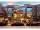 Modern brick townhomes with rooftop decks, sleek architectural details, and street parking create an inviting facade at 2900 Inca St # 7, Denver, CO 80202