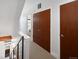 Hallway with wooden doors, white walls, and carpeted floor, leading to other rooms in the house at 2900 Inca St # 7, Denver, CO 80202