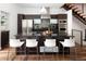 Modern kitchen with dark wood cabinets, stainless steel appliances, a large island with seating, and hardwood floors at 2900 Inca St # 7, Denver, CO 80202