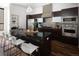 Kitchen with a large island, stainless steel appliances, granite countertops, and modern dark wood cabinetry at 2900 Inca St # 7, Denver, CO 80202