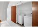Convenient laundry area with side-by-side washer and dryer and ample storage at 2900 Inca St # 7, Denver, CO 80202