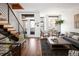 Open living area with stylish decor, hardwood floors, modern staircase, and comfortable seating arrangement at 2900 Inca St # 7, Denver, CO 80202