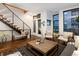 Inviting living room with modern staircase, hardwood floors, natural light, and comfortable seating at 2900 Inca St # 7, Denver, CO 80202