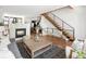 Bright and airy living room with fireplace, hardwood floors, and modern staircase at 2900 Inca St # 7, Denver, CO 80202