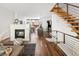 Open-concept living room with modern fireplace, kitchen view, and adjacent dining area at 2900 Inca St # 7, Denver, CO 80202
