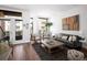 Cozy living room featuring a comfortable gray sofa and balcony access at 2900 Inca St # 7, Denver, CO 80202