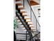 Modern staircase featuring sleek metal railings and wood steps, creating a stylish and contemporary design at 2900 Inca St # 7, Denver, CO 80202