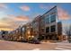 Street view showcases modern brick townhomes with rooftop decks and sleek architectural details on a quiet street at 2900 Inca St # 7, Denver, CO 80202