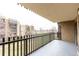 Relaxing covered balcony with black metal railings and neutral toned flooring overlooking exterior common areas at 14050 E Linvale Pl # 309, Aurora, CO 80014