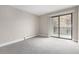 Bright and spacious bedroom with a balcony, neutral paint, and large sliding glass doors at 14050 E Linvale Pl # 309, Aurora, CO 80014