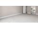 Bright bedroom with neutral walls and grey carpet, open to storage shelves at 14050 E Linvale Pl # 309, Aurora, CO 80014