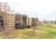 A scenic exterior view shows the building overlooking lush green spaces and a serene environment at 14050 E Linvale Pl # 309, Aurora, CO 80014