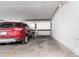 Assigned garage parking space with a red SUV parked inside and white storage lockers at 14050 E Linvale Pl # 309, Aurora, CO 80014