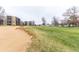 Scenic view of the golf course with lush green grass and a sand trap near the condominium at 14050 E Linvale Pl # 309, Aurora, CO 80014