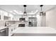 Modern kitchen featuring white cabinets, stainless steel appliances and a large island at 14050 E Linvale Pl # 309, Aurora, CO 80014