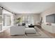 Bright living room features sliding barn doors, balcony access and light, neutral decor at 14050 E Linvale Pl # 309, Aurora, CO 80014