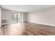 Bright living room featuring wood-look floors and sliding glass door to private balcony at 14050 E Linvale Pl # 309, Aurora, CO 80014