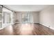 Open concept living room with hardwood floors and sliding doors to carpeted bedroom and balcony at 14050 E Linvale Pl # 309, Aurora, CO 80014