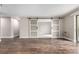 Spacious living room with hardwood floors and sliding barn doors at 14050 E Linvale Pl # 309, Aurora, CO 80014