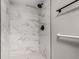 Tiled shower with black hardware, a rainfall shower head, and elegant marble-look tiling at 14050 E Linvale Pl # 309, Aurora, CO 80014