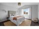 Bright bedroom featuring a bed, natural light, a jute rug, and light colored walls at 3738 Black Feather Trl, Castle Rock, CO 80104