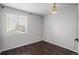 Minimalist bedroom with light walls, wood floor, and a bright window to let in sunlight at 3738 Black Feather Trl, Castle Rock, CO 80104